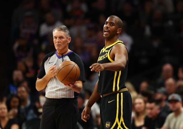 Golden State Warriors guard Chris Paul alongside NBA referee Scott Foster against the Phoenix Suns in the first half at Footprint Center in Phoenix on Nov. 22, 2023.